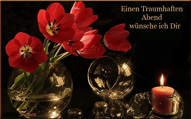 ᐅ allerheiligen gif - Allerheiligen plaatjes Vaas met rode tulpen, een brandende kaars en een sfeervolle achtergrond.