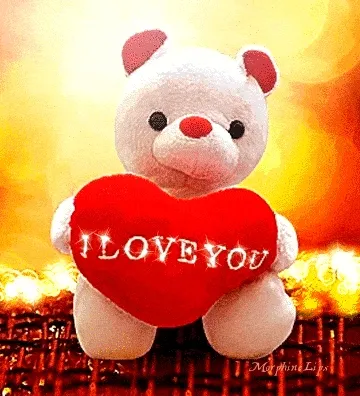 Een schattige witte teddybeer met een rood hart dat 'I LOVE YOU' zegt.