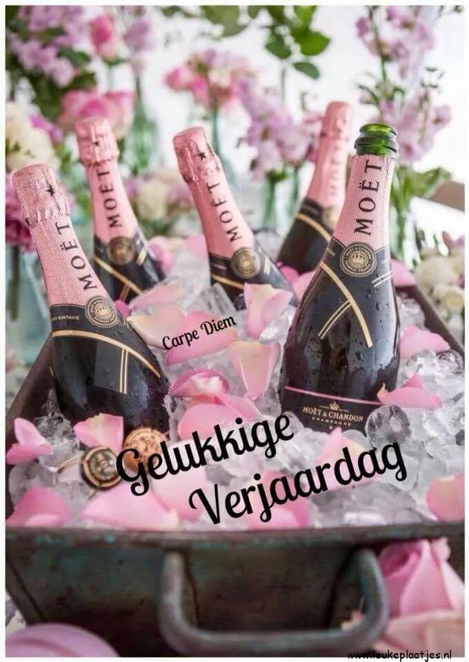 Flesse champagne in een ijsbad met rozenblaadjes en verjaardagswens.